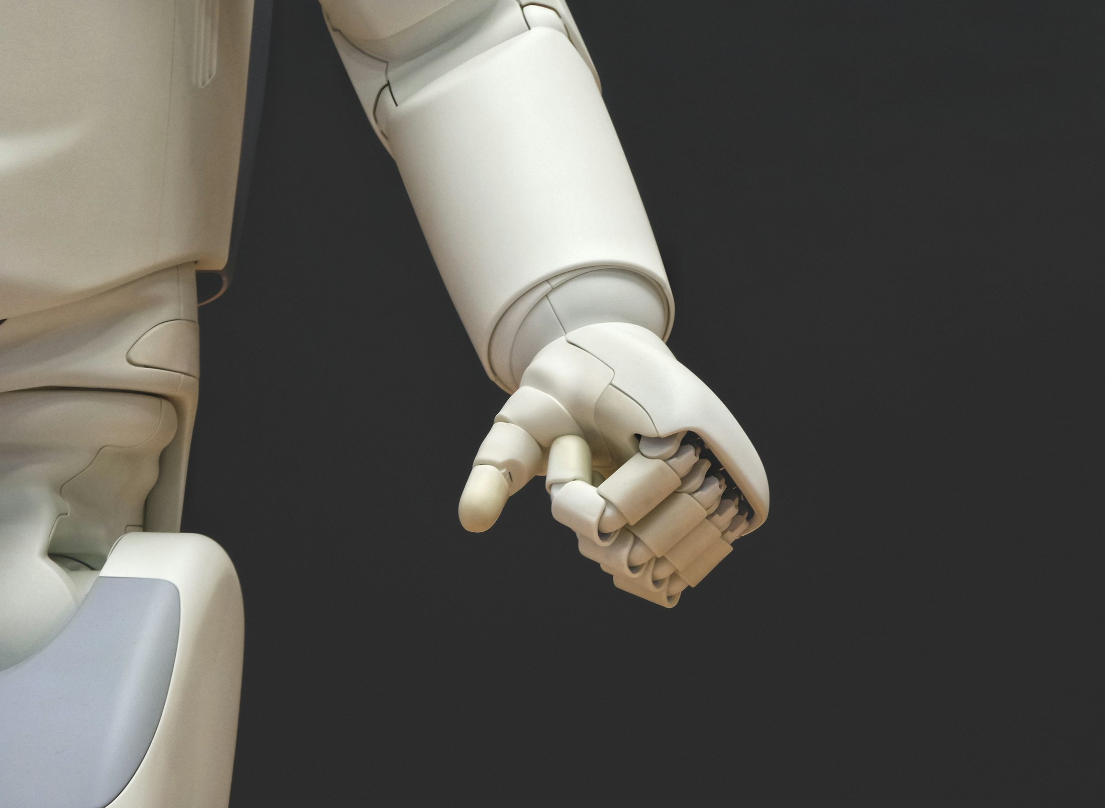 A white robot hand reaching out
